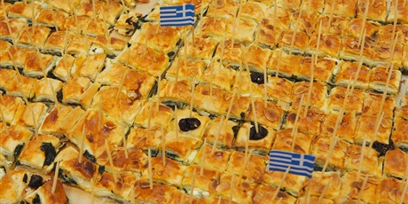Powiększ grafikę: Obraz przedstawia wiele kawałków potrawy kuchni Greckiej, w które są wbite wykałaczki (na dwóch widnieje flaga Grecji).